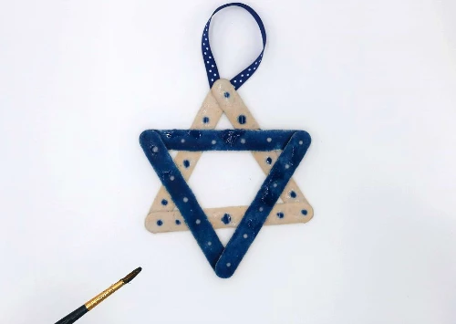 Create a Star of David ornament for Hanukkah with colored sand and glue! #HanukkahCrafts #Hanukkah
